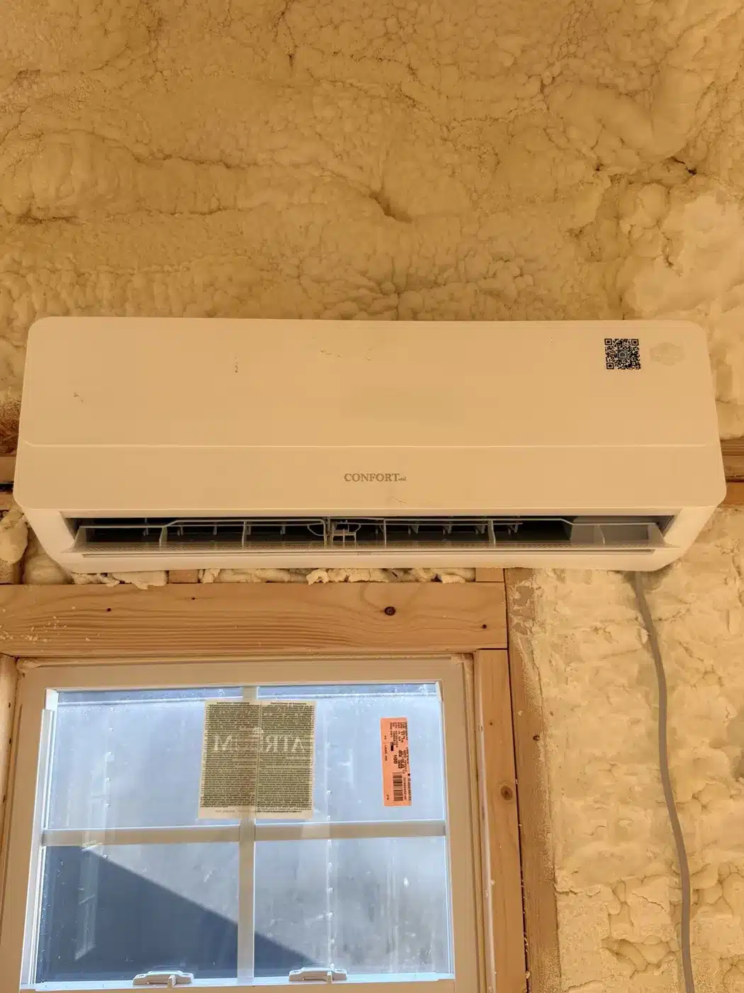 Interior mini-split HVAC unit mounted above a window